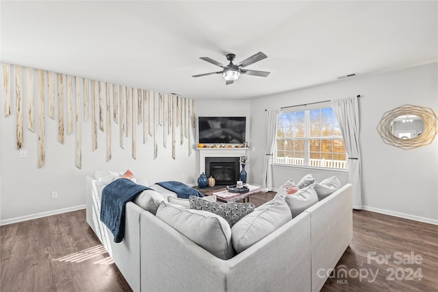 living room with dark hardwood / wood-style flooring and ceiling fan