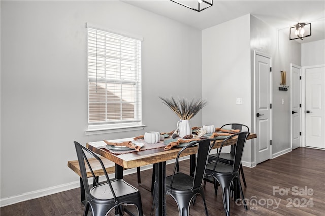 dining room featuring a notable chandelier and dark wood-type flooring