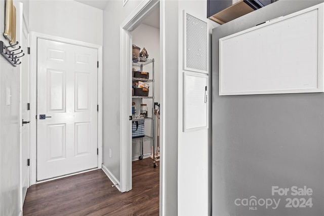 corridor with dark hardwood / wood-style floors