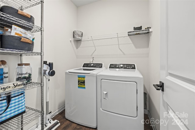 laundry room with washer and clothes dryer and dark wood-type flooring