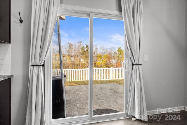 entryway featuring a healthy amount of sunlight and hardwood / wood-style flooring