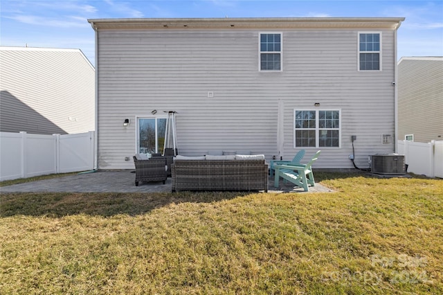 back of property featuring a lawn, an outdoor living space, cooling unit, and a patio