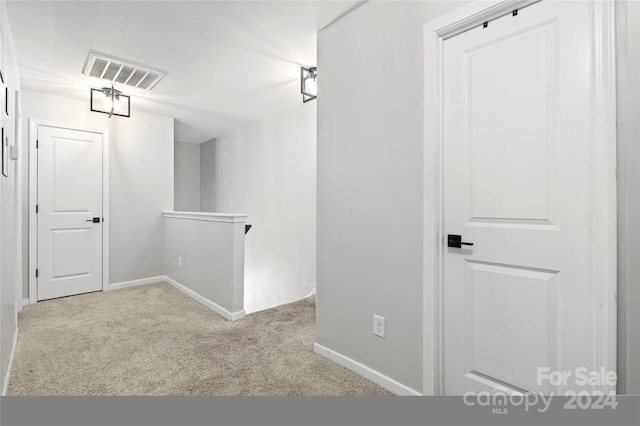 hallway with light colored carpet