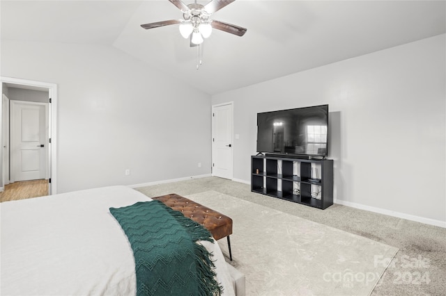 carpeted bedroom featuring ceiling fan and vaulted ceiling