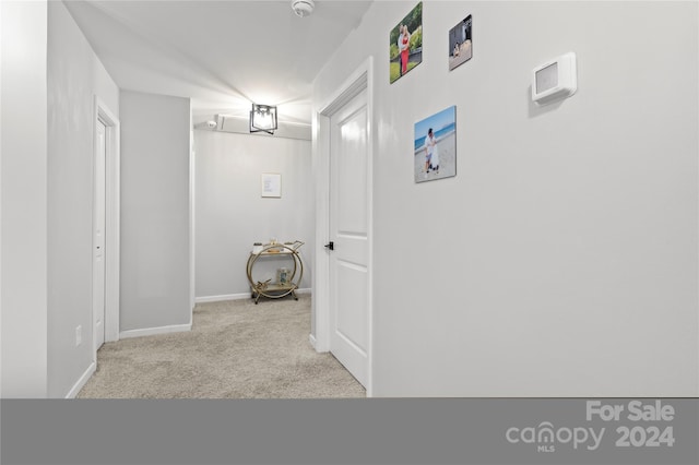 hallway with light colored carpet