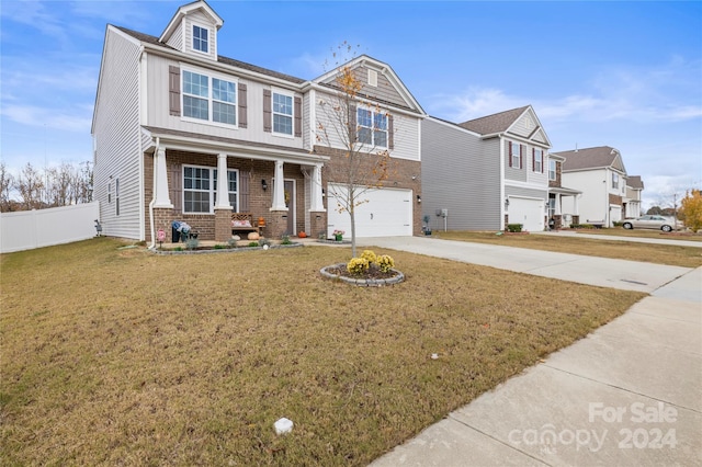 view of front of property with covered porch, a garage, and a front lawn