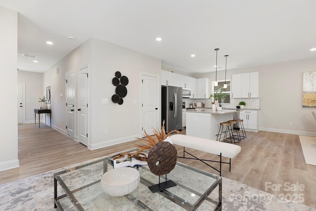 living room with light hardwood / wood-style flooring