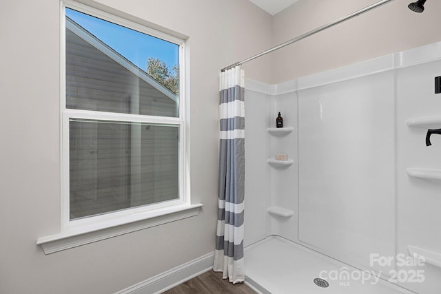 bathroom featuring hardwood / wood-style flooring and walk in shower