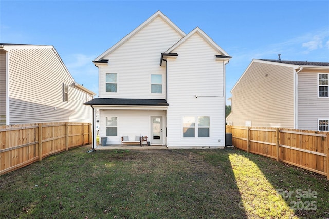 rear view of property featuring a lawn and a patio area