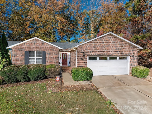 ranch-style house with a front lawn and a garage