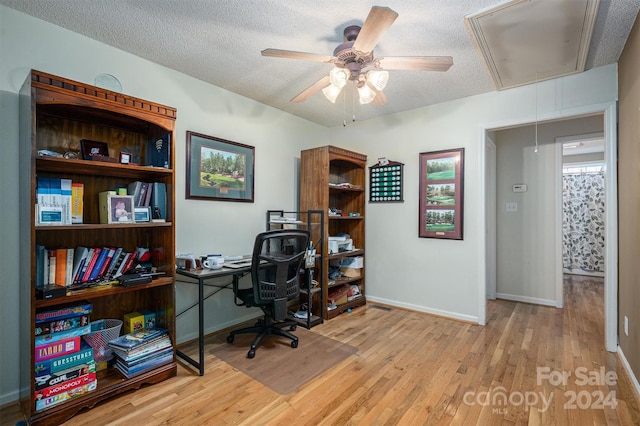 office featuring ceiling fan, light hardwood / wood-style flooring, and a textured ceiling