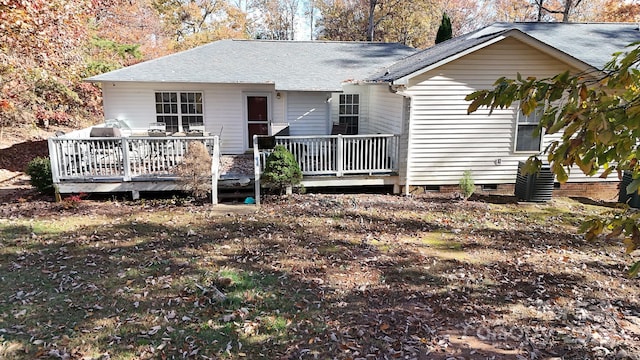 rear view of house featuring a wooden deck