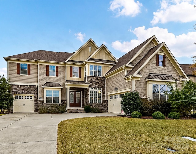 craftsman inspired home featuring french doors, a front lawn, and a garage