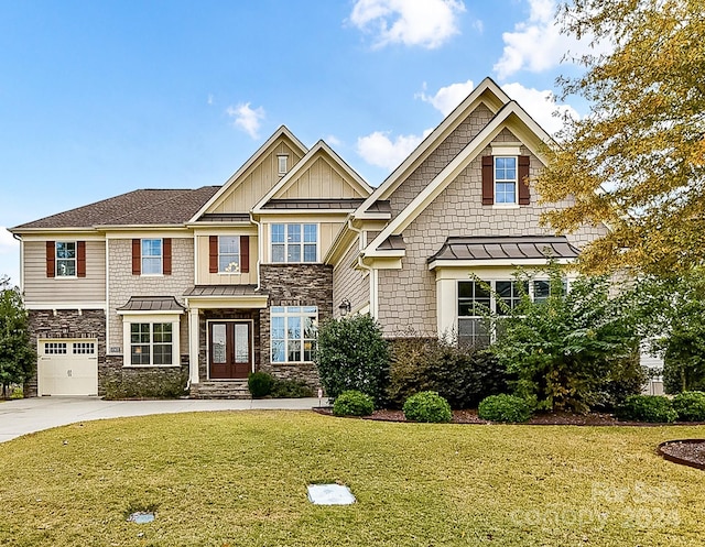 craftsman-style house featuring a garage, a front yard, and french doors