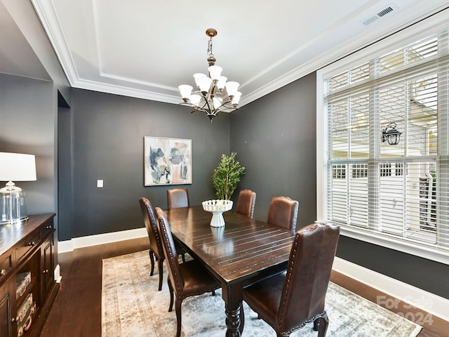 dining space with ornamental molding, dark hardwood / wood-style floors, and a notable chandelier