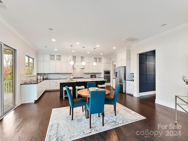 dining space with crown molding and dark hardwood / wood-style flooring