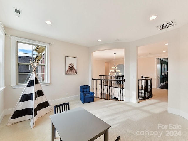 living area featuring carpet flooring, an inviting chandelier, and crown molding