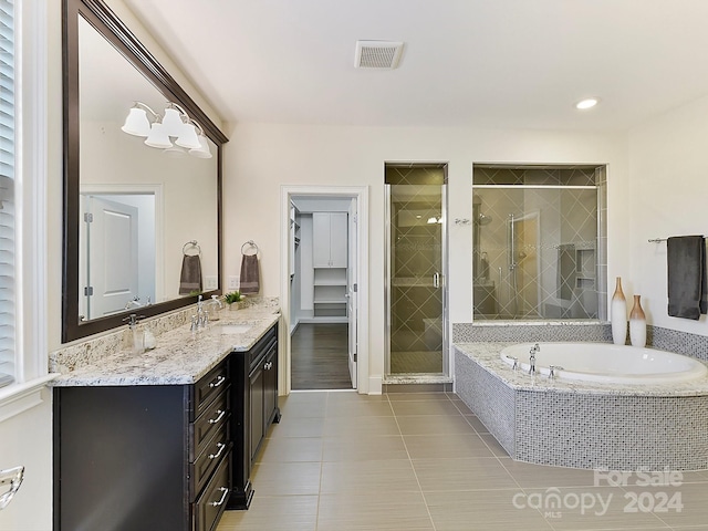 bathroom featuring tile patterned flooring, vanity, and independent shower and bath