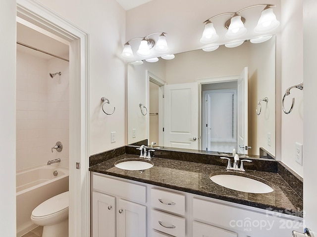 full bathroom with vanity, toilet, and tiled shower / bath