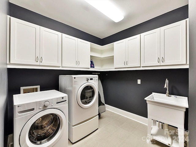 clothes washing area featuring light tile patterned flooring, cabinets, and independent washer and dryer