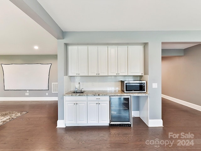 kitchen featuring white cabinets, dark wood-type flooring, and wine cooler