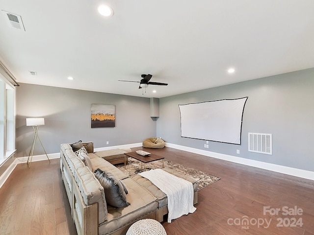 home theater with ceiling fan and dark hardwood / wood-style floors