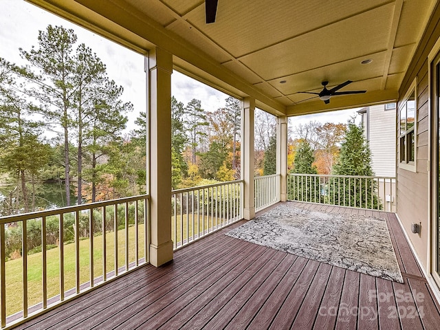 deck with ceiling fan and a yard