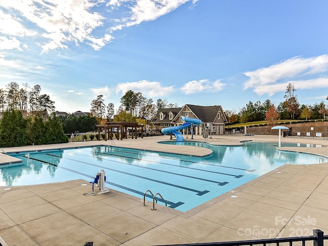 view of pool featuring a patio area and a water slide