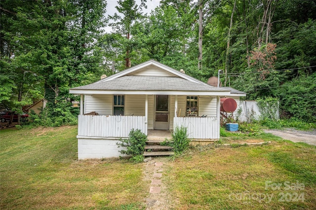 bungalow-style home with a porch and a front lawn