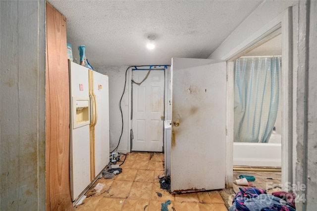 laundry room with a textured ceiling