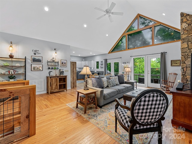 living room featuring ceiling fan, french doors, high vaulted ceiling, and light hardwood / wood-style floors