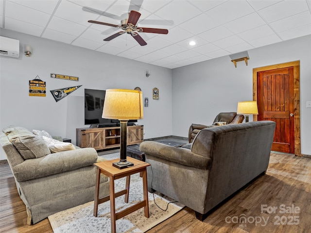 living area featuring recessed lighting, ceiling fan, a wall unit AC, and wood finished floors