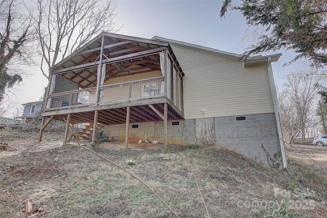 back of property with ceiling fan and a deck