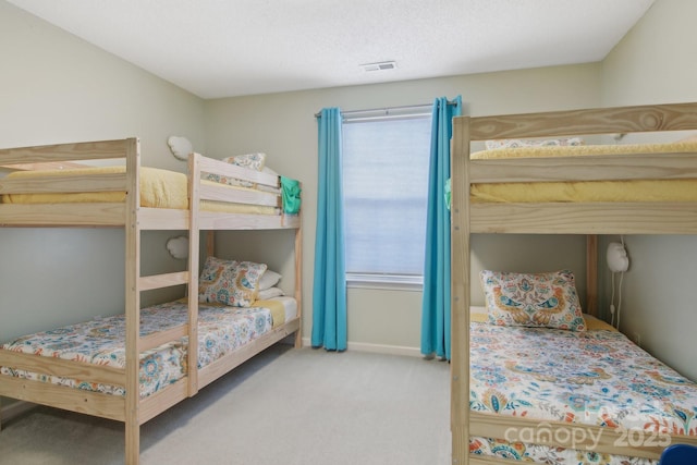 bedroom with carpet floors and a textured ceiling