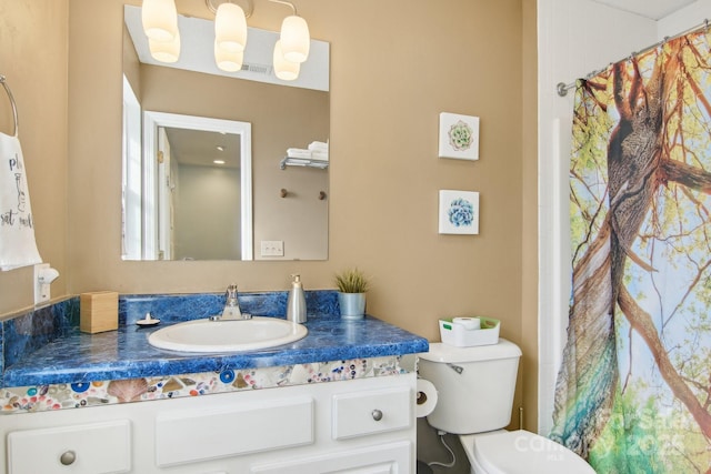 bathroom featuring vanity and toilet