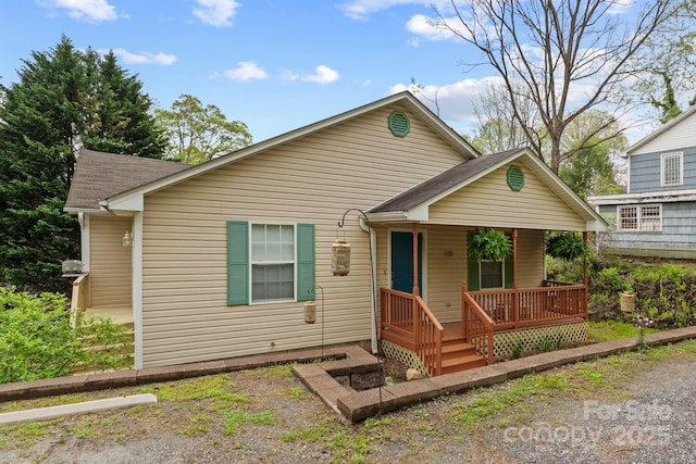 bungalow featuring covered porch and a shingled roof