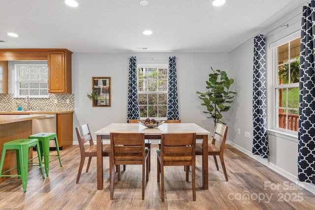 dining area with recessed lighting, baseboards, and light wood-style floors
