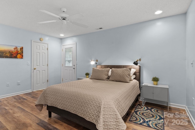 bedroom with baseboards, visible vents, wood finished floors, and a ceiling fan