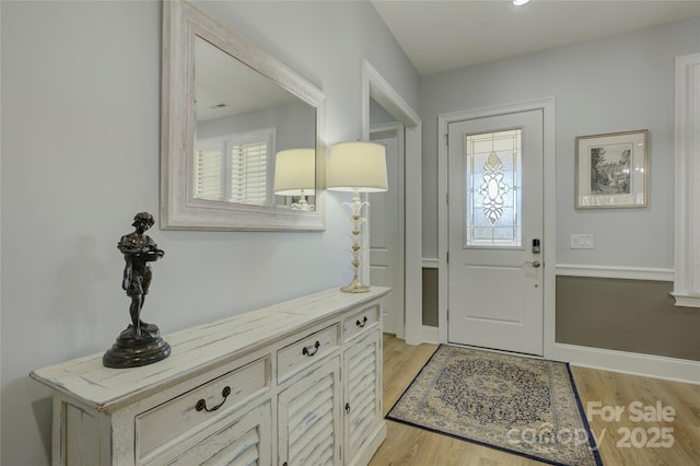 foyer entrance with light hardwood / wood-style floors and plenty of natural light