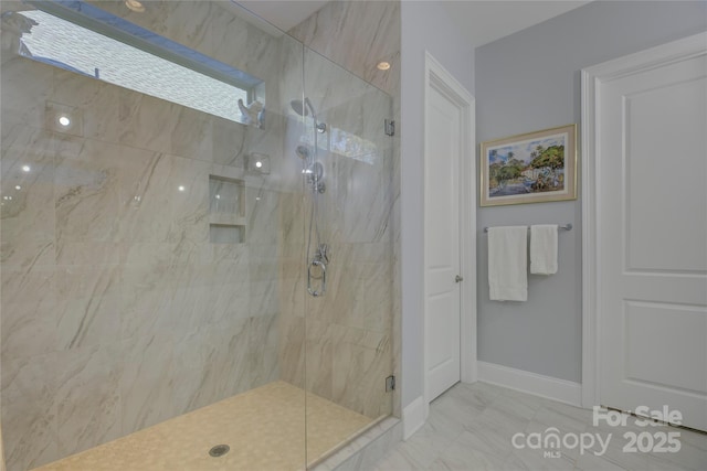 bathroom with a shower with door