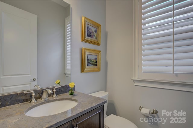 bathroom with toilet and vanity