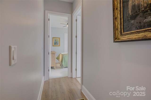 hallway with light hardwood / wood-style floors