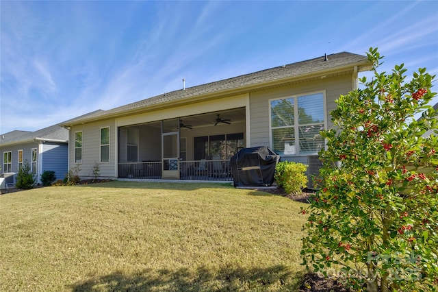 back of house with a lawn and a sunroom