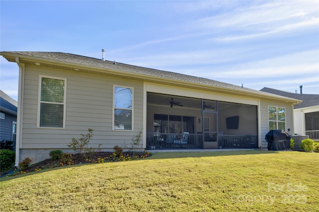 back of property featuring a sunroom and a lawn