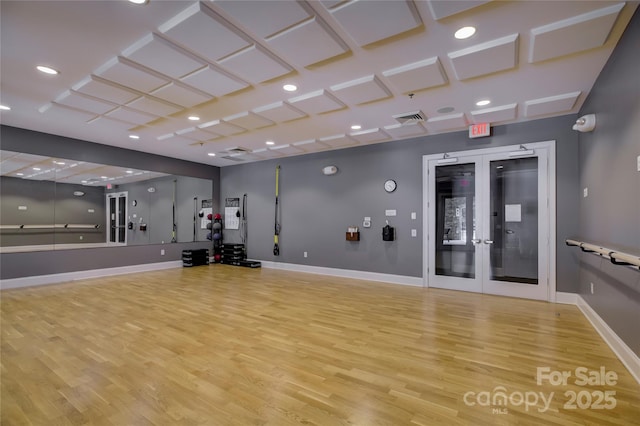 exercise room featuring french doors and light hardwood / wood-style flooring