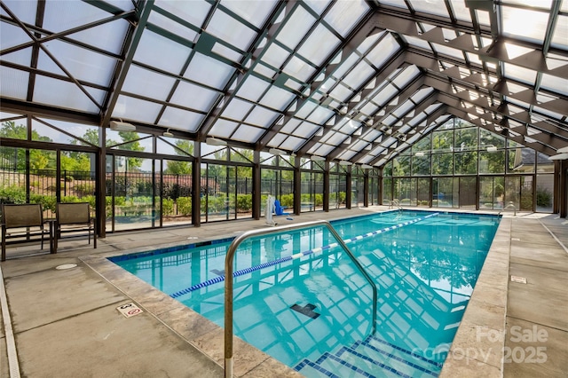 view of swimming pool with a lanai and a patio