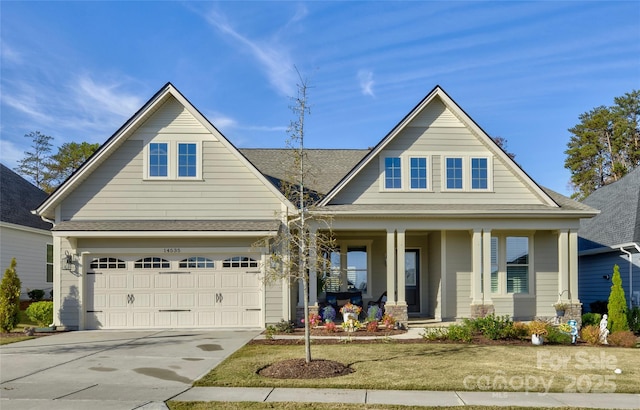 view of front of home featuring a porch and a garage