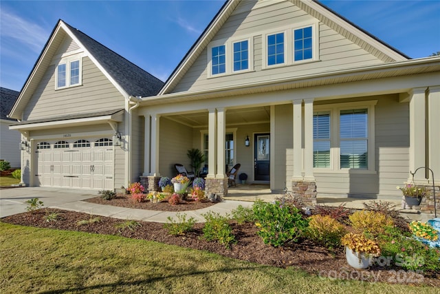 view of front of home with covered porch and a garage