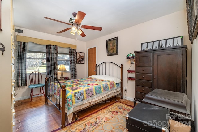 bedroom with hardwood / wood-style floors and ceiling fan