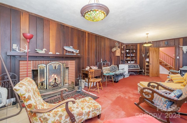 living room featuring wooden walls, a fireplace, and carpet